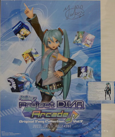 Yuki Dong with autographed poster promoting Hatsune Miku Project Diva Arcade Song Collection 2 CD with her song.